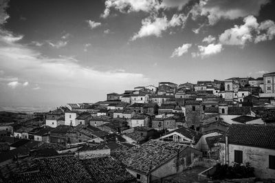 Houses in city against sky