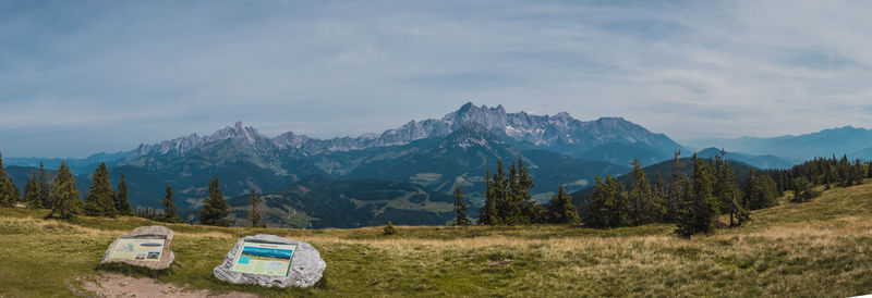 Scenic view of field and mountains against sky