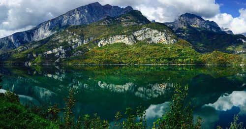 Scenic view of lake and mountains against sky
