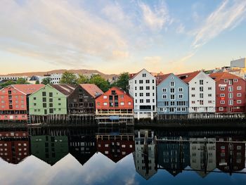 Reflection of buildings in river, trondheim, norway