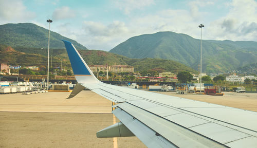 Airplane wing against sky