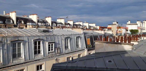 High angle view of buildings against cloudy sky