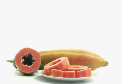 Close-up of chopped fruits against white background