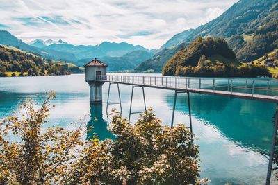 Scenic view of lake by mountains against sky