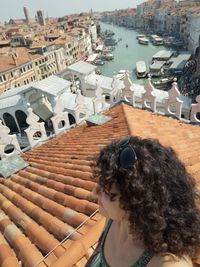 High angle view of woman by sea against buildings