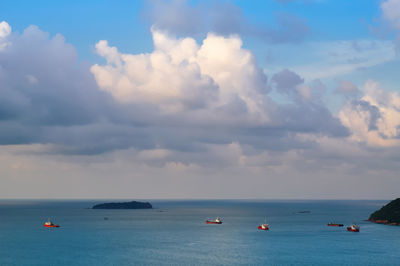 Boats sailing in sea against sky