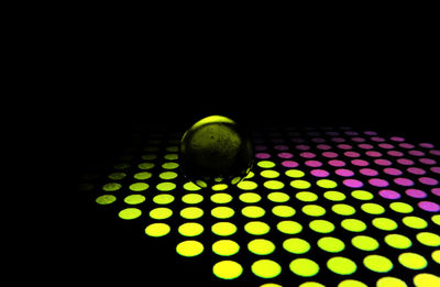 Close-up of illuminated lighting equipment in darkroom