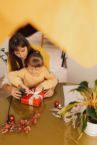 A happy family mother and child pack christmas gifts. lifestyle. new year gifts. 