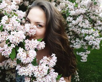 Portrait of beautiful woman amidst flowers