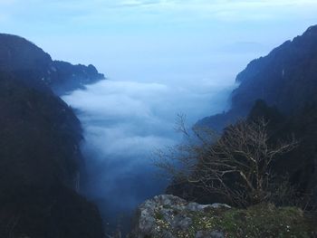 Scenic view of sea and mountains against sky