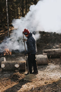 View of woman raking