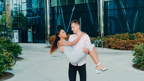 Young couple standing in city