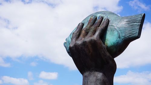 Low angle view of statue against sky