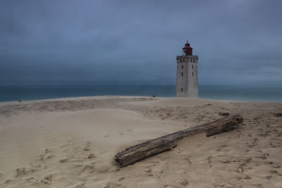 Lighthouse rubjerg knude at sunset on a stormy evening with dramatic sky