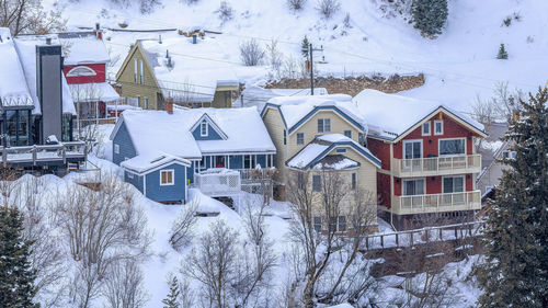 Snow covered houses and buildings in city