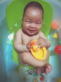 Portrait of cute baby girl with toy