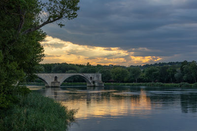 Arch bridge over river against sky