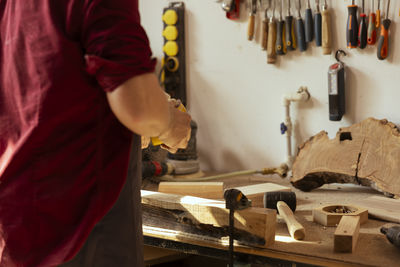 Midsection of man working at workshop