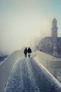 Full length of woman walking on footbridge