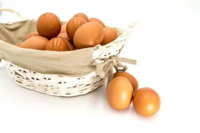 Close-up of orange eggs against white background