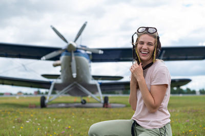 Portrait of smiling young woman on field