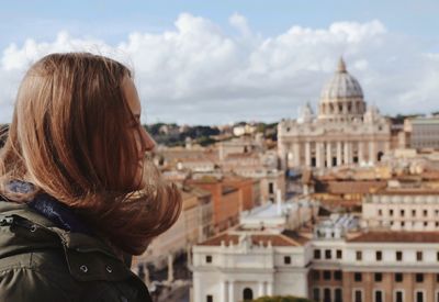 Rear view of woman looking at city buildings