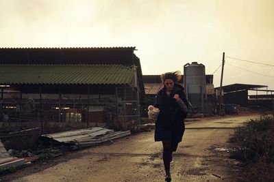 Woman standing on railroad track