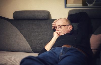 Man sleeping on sofa at home