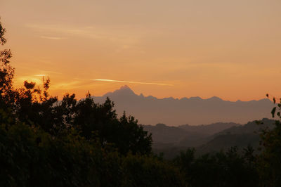 Scenic view of silhouette mountains against sky at sunset