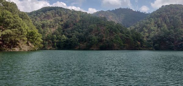 Scenic view of lake and mountains against sky