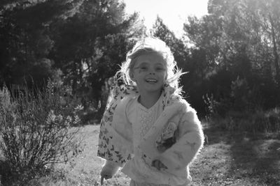 Portrait of happy girl running in park