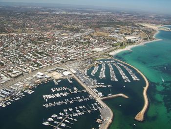 High angle view of cityscape and sea seen from airplane