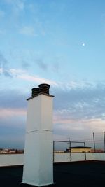 Lighthouse against cloudy sky