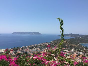 Scenic view of sea and mountains against clear sky