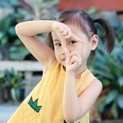 Positive charming 4 years old cute baby asian girl, little child with adorable pigtails hair smiling