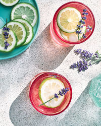 Cool lavender lemonade with lime slices and lavender flower on the table