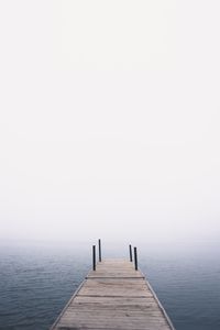 Pier over sea against clear sky