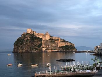 Scenic view of sea and buildings against sky