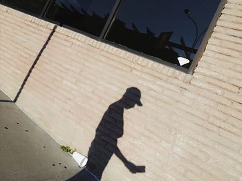 High angle view of man shadow on woman in city
