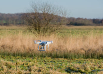 Drone flying over field