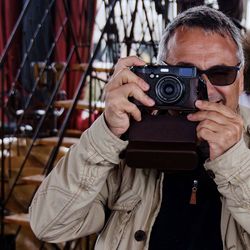 Mature man photographing by steps