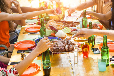 Midsection of cheerful friends partying outdoors