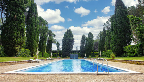 View of swimming pool against cloudy sky