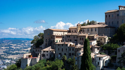 Buildings in town against sky