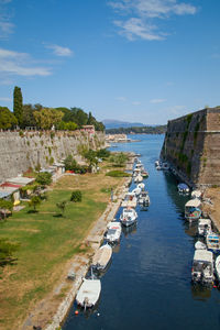 Canal between old fortress and old town corfu town, kerkyra greece, with small sailing boats