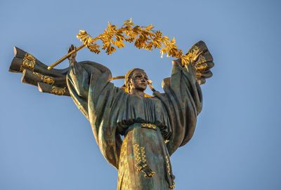 Low angle view of angel statue against clear sky