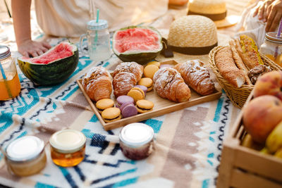 Cropped hand of woman holding food on table