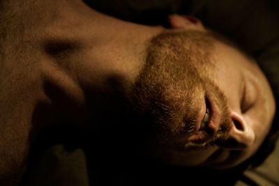 Close-up of shirtless man with eyes closed