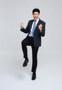 Portrait of young man against white background