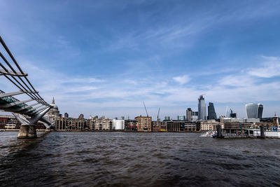 View of city buildings against cloudy sky